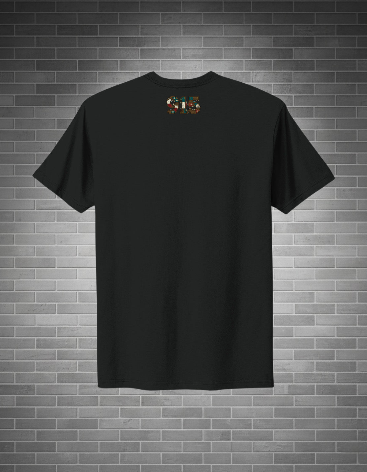 Black t-shirt with a small logo on a brick wall background