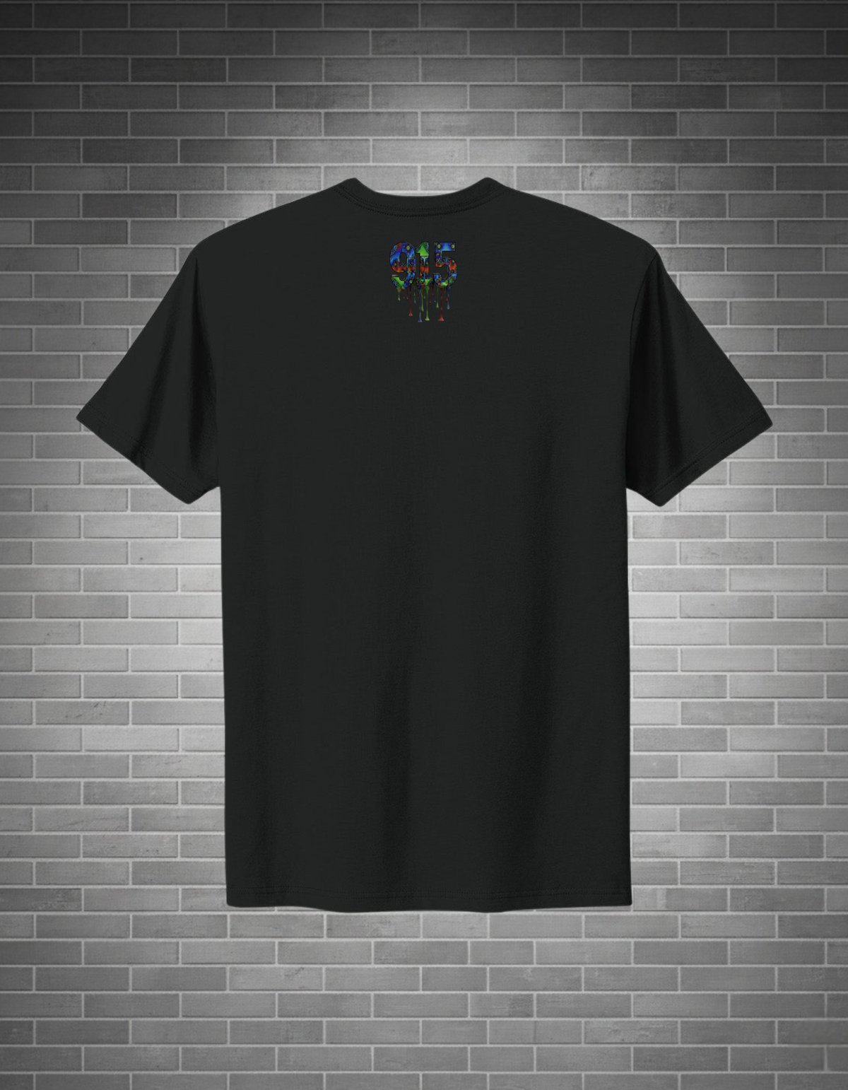 Black t-shirt with a colorful design on the back against a brick wall background