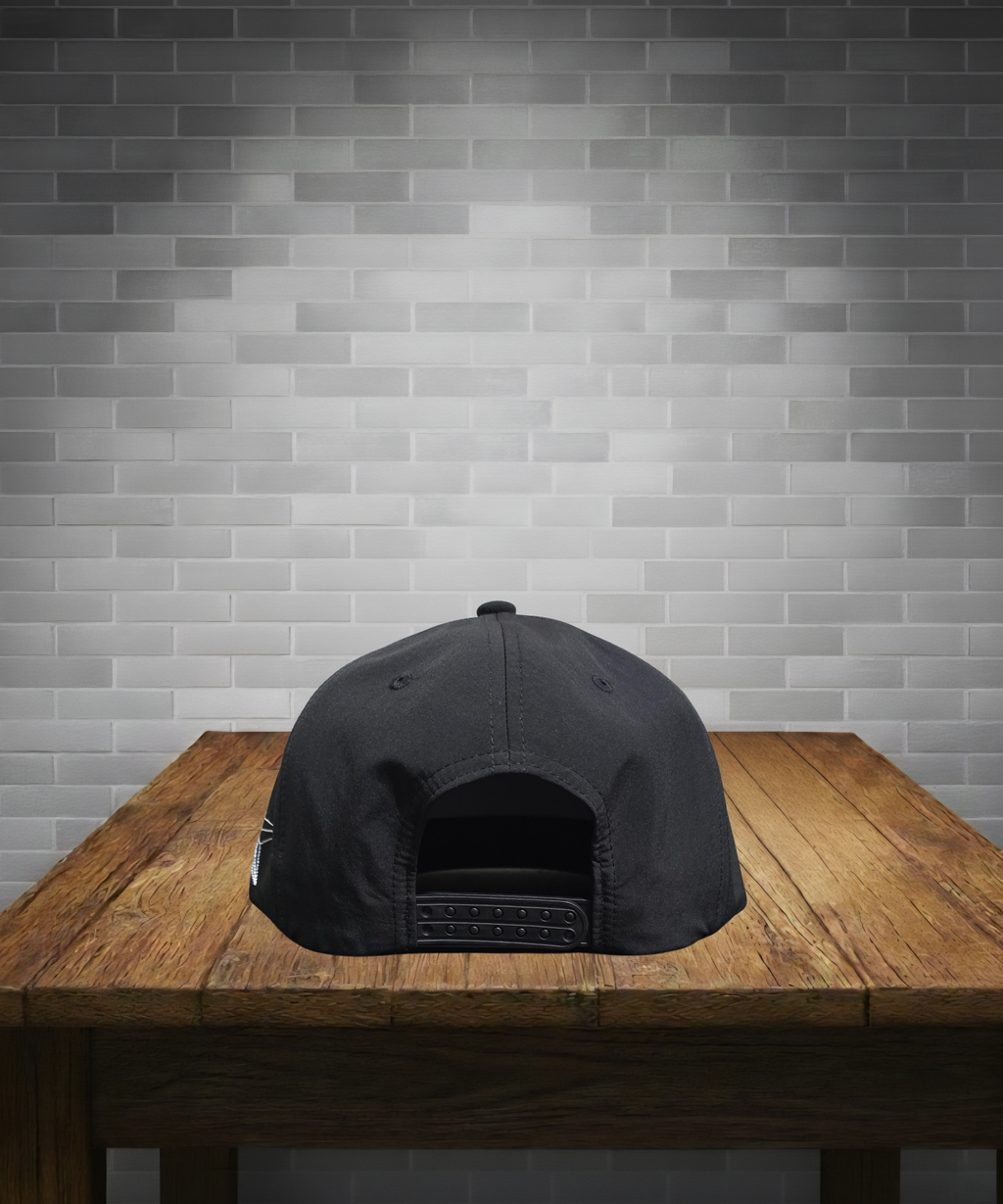 Black cap on a wooden table with a gray brick wall background
