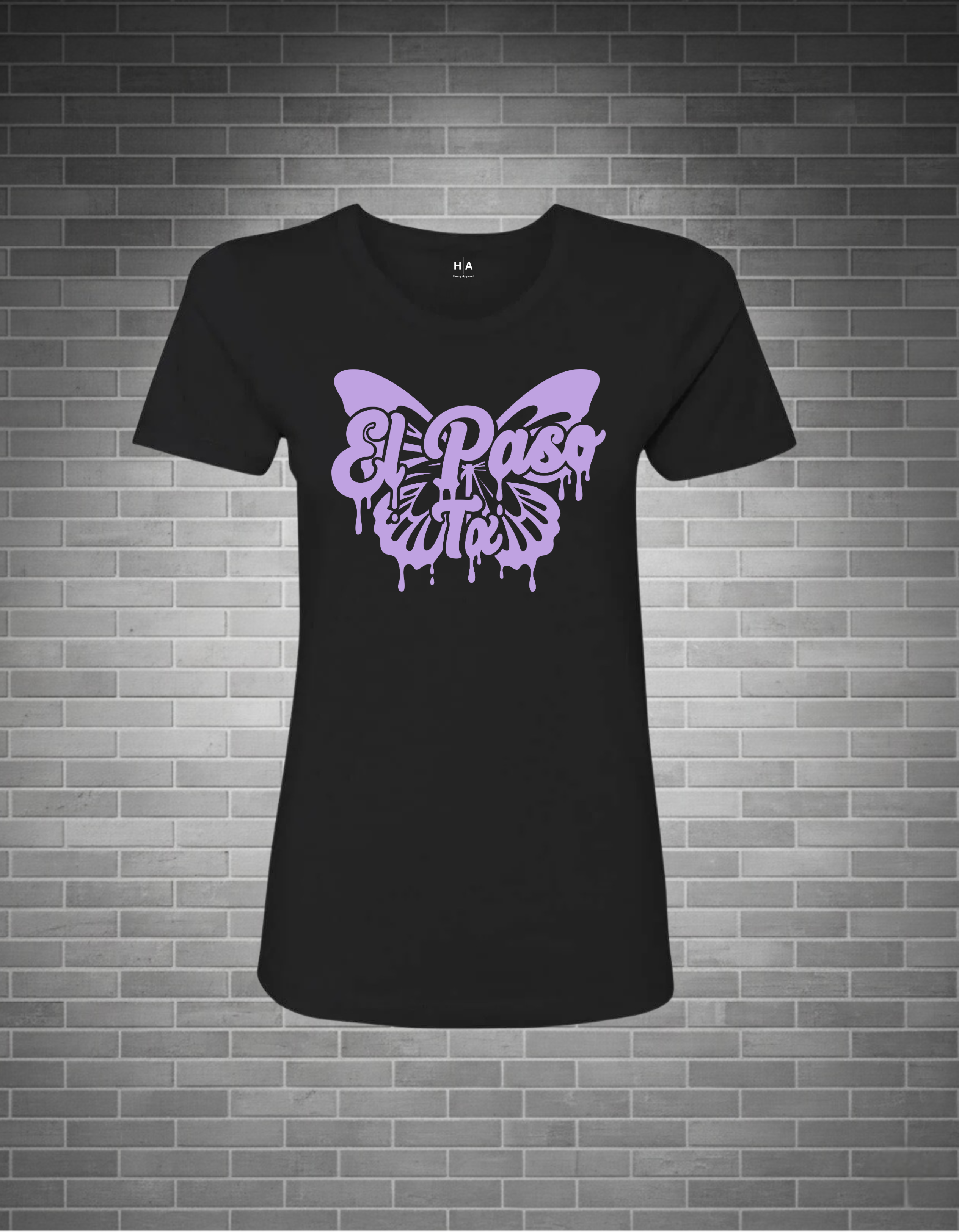 Black t-shirt with purple butterfly design and 'El Paso' text on a brick wall background