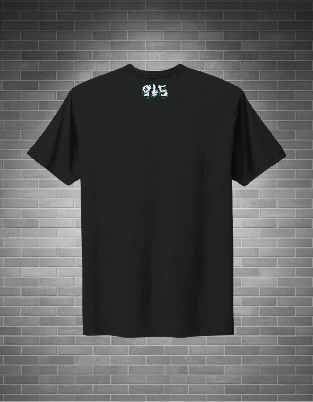 Black t-shirt with a logo on the back against a brick wall background