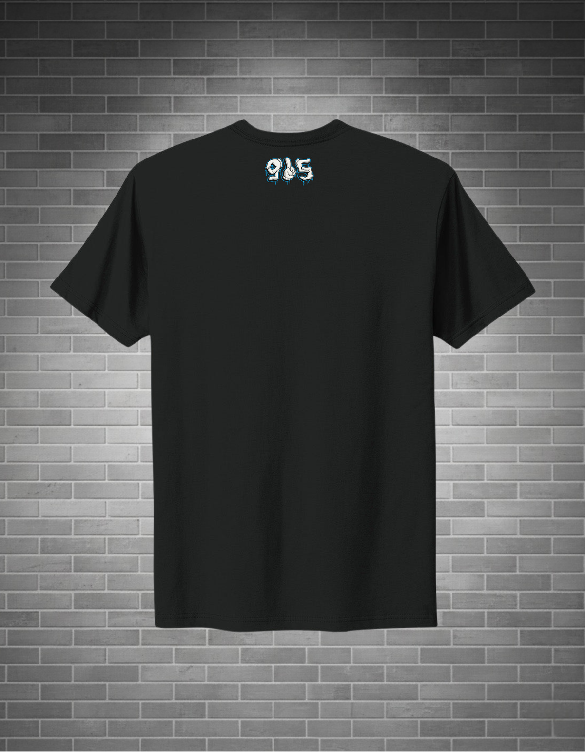 Black t-shirt with a logo on the back against a brick wall background