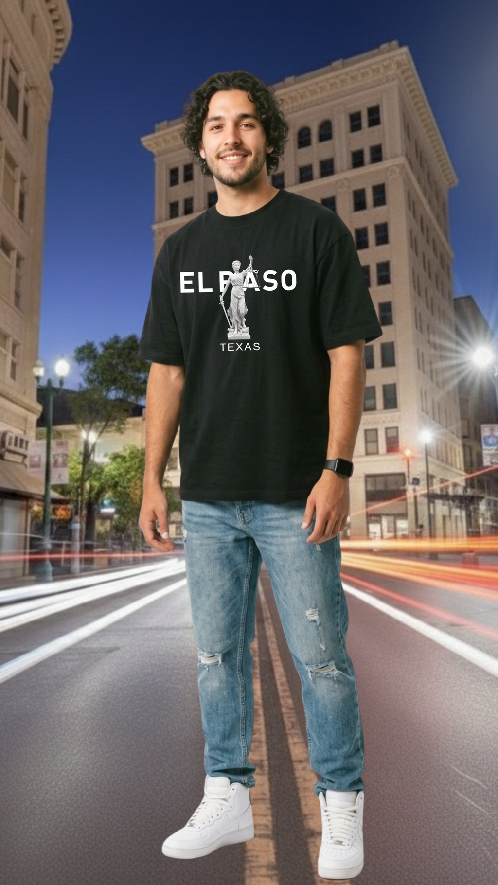 Man wearing a black t-shirt with 'El Paso Texas' design on a city street at night.