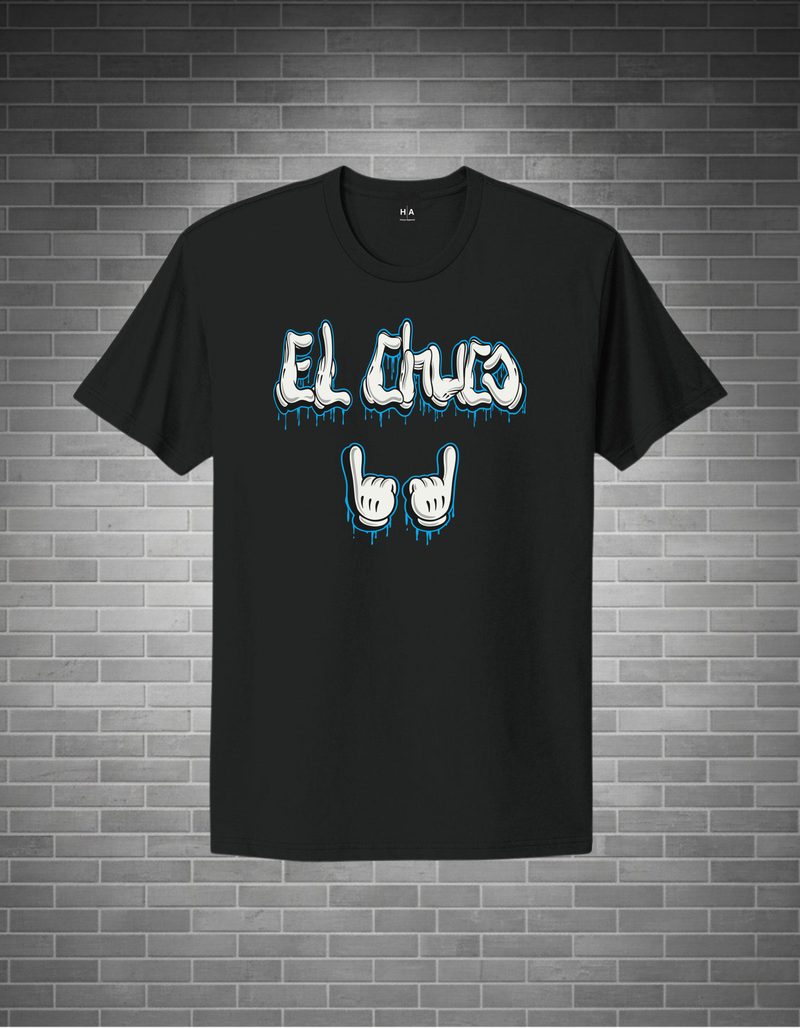 Black t-shirt with 'El Cluco' text and hand signs on a brick wall background