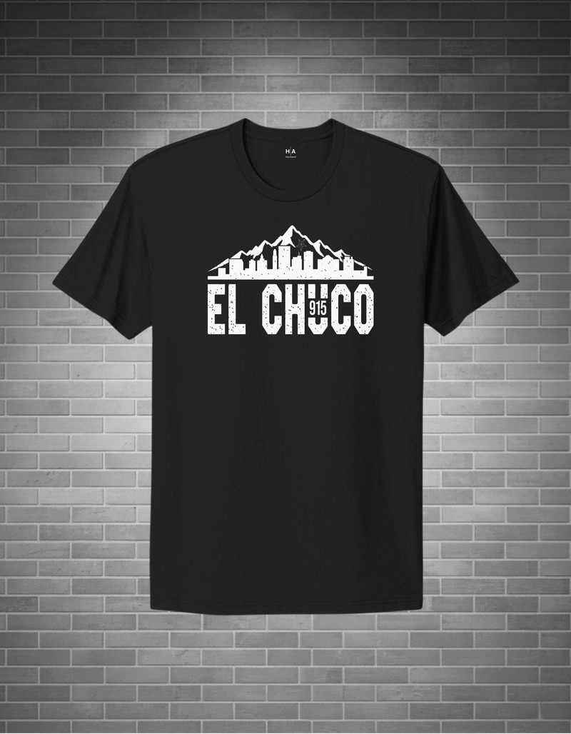 Black t-shirt with 'El Chuco' graphic design on a brick wall background