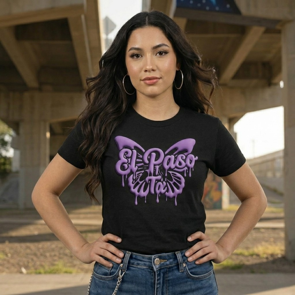Woman wearing a black t-shirt with a purple butterfly design and 'El Paso' text, standing outdoors.