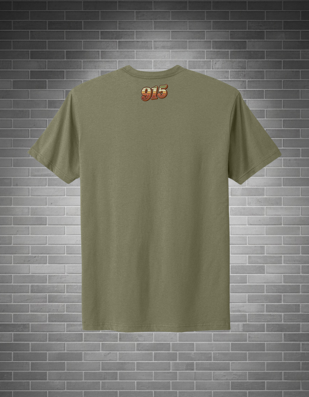 Green t-shirt with a logo on the back against a brick wall background