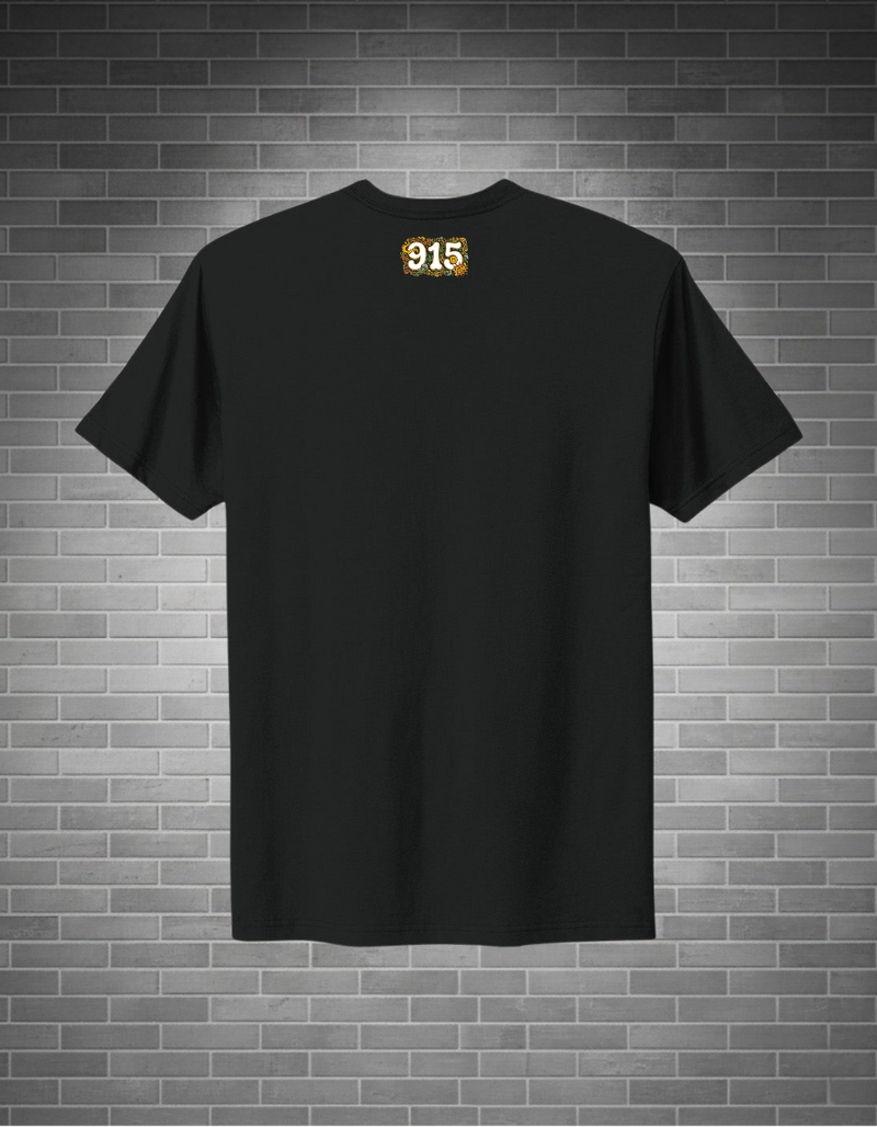 Black t-shirt with a logo on the back against a brick wall background