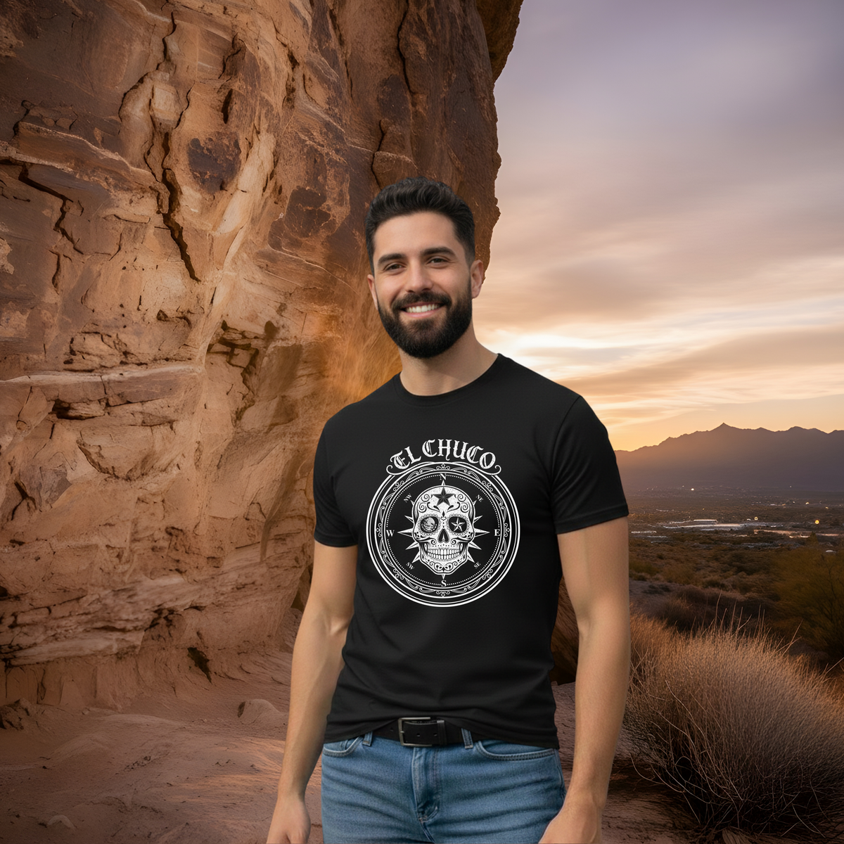 Man wearing el paso inspired shirt with "El Chuco" and a skull with a scenic mountain background