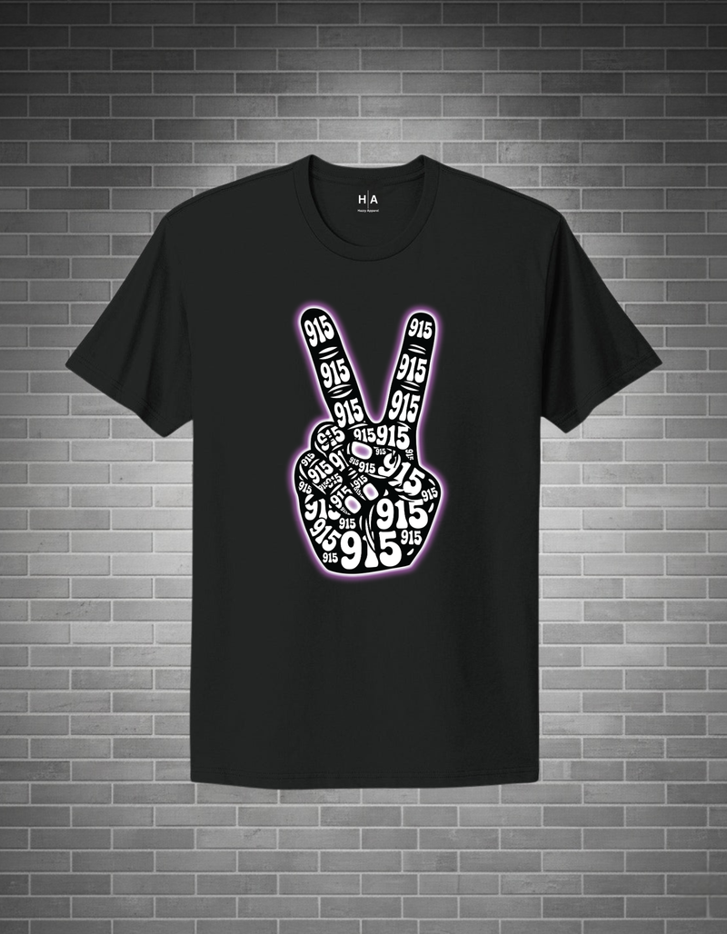 Black t-shirt with peace sign design on a brick wall background