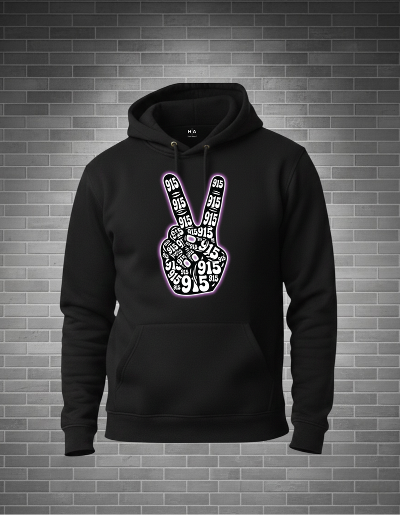 Black hoodie with peace sign design on a brick wall background
