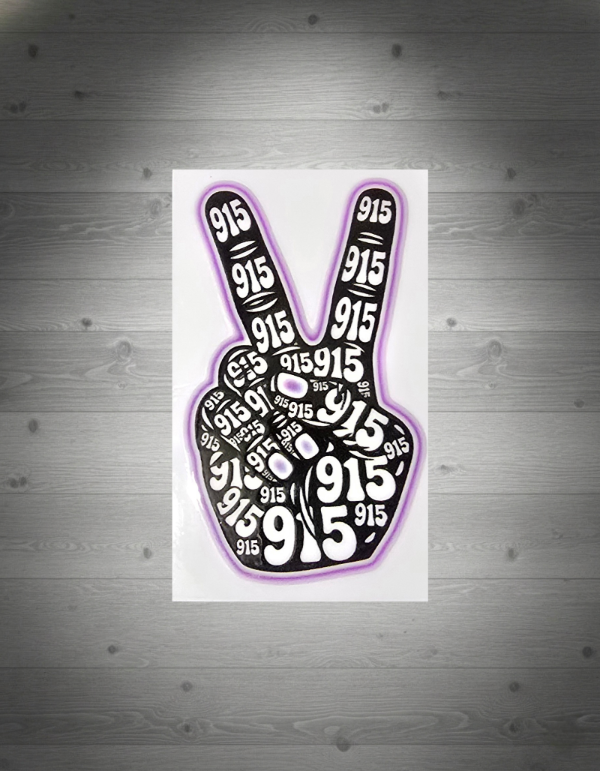 Peace sign with '915' printed multiple times on a white grey wooden background