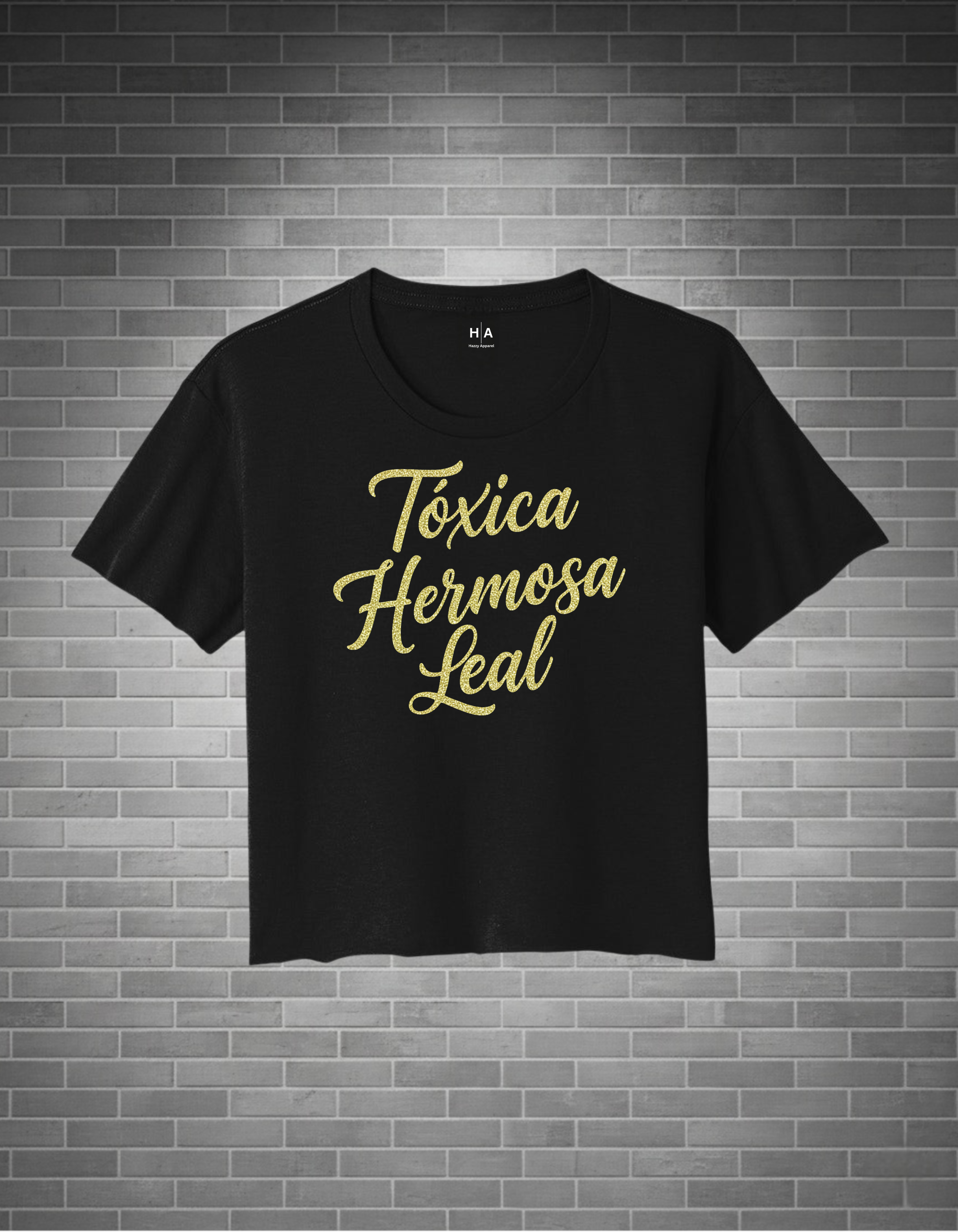 Black t-shirt with gold text on a brick wall background