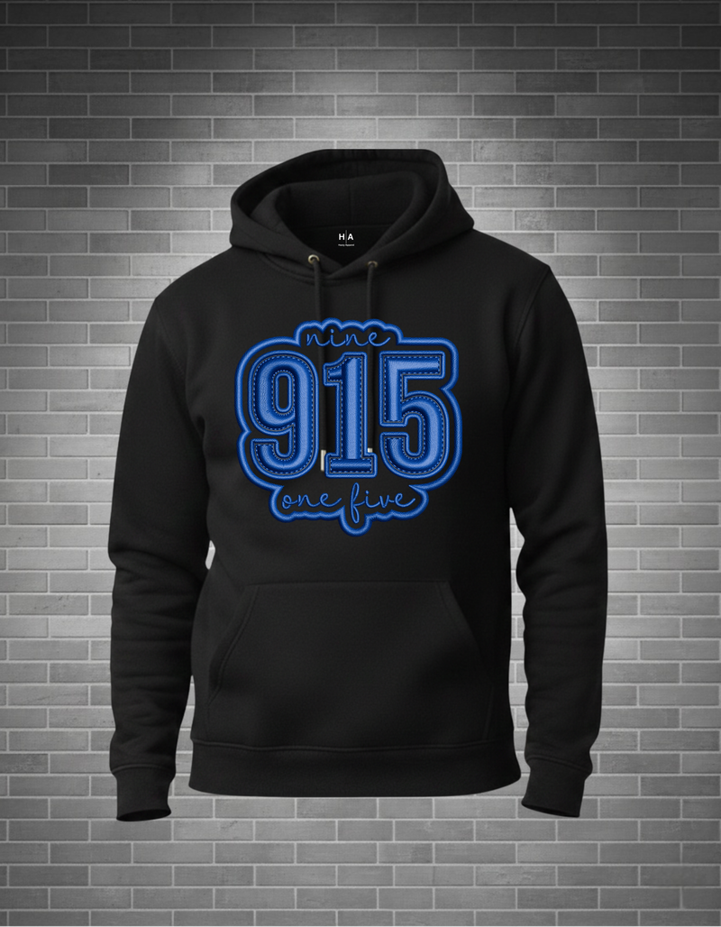 Black hoodie with blue text '915 one five' on a brick wall background