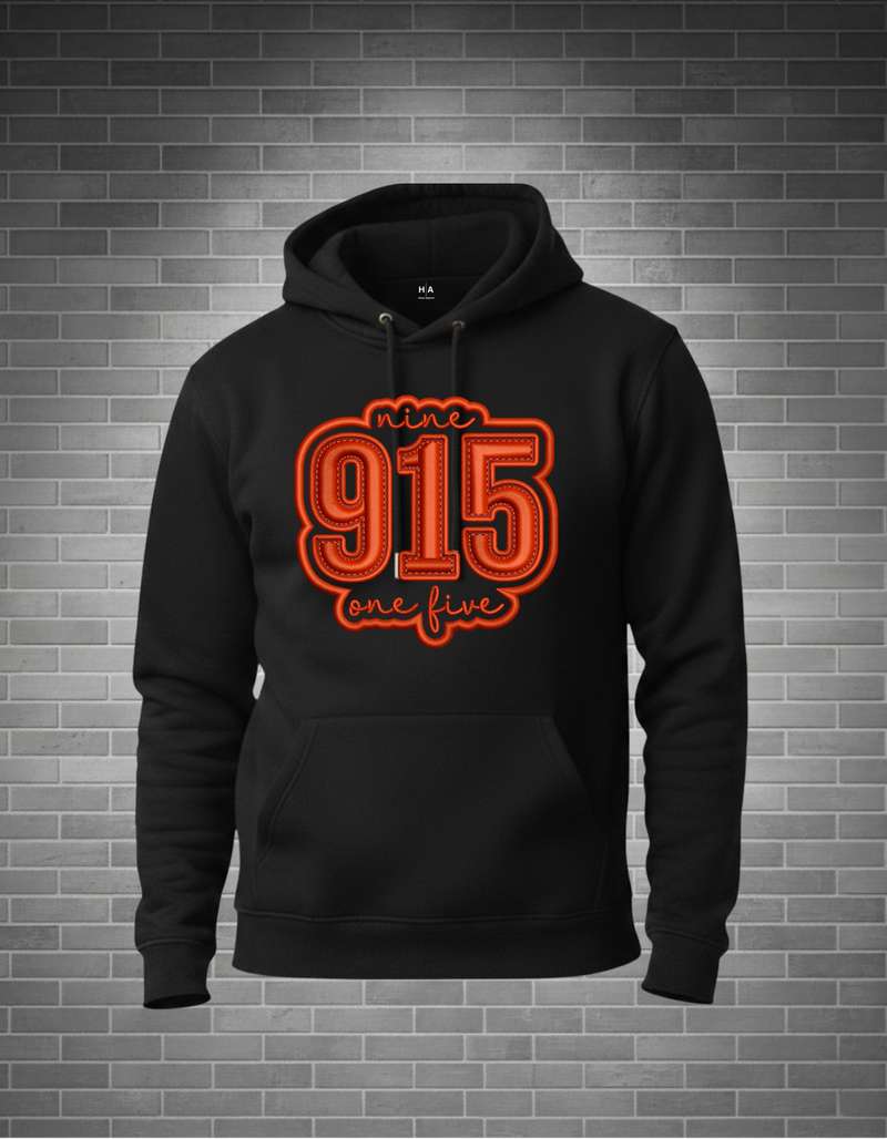 Black hoodie with red text '915 one five' on a brick wall background