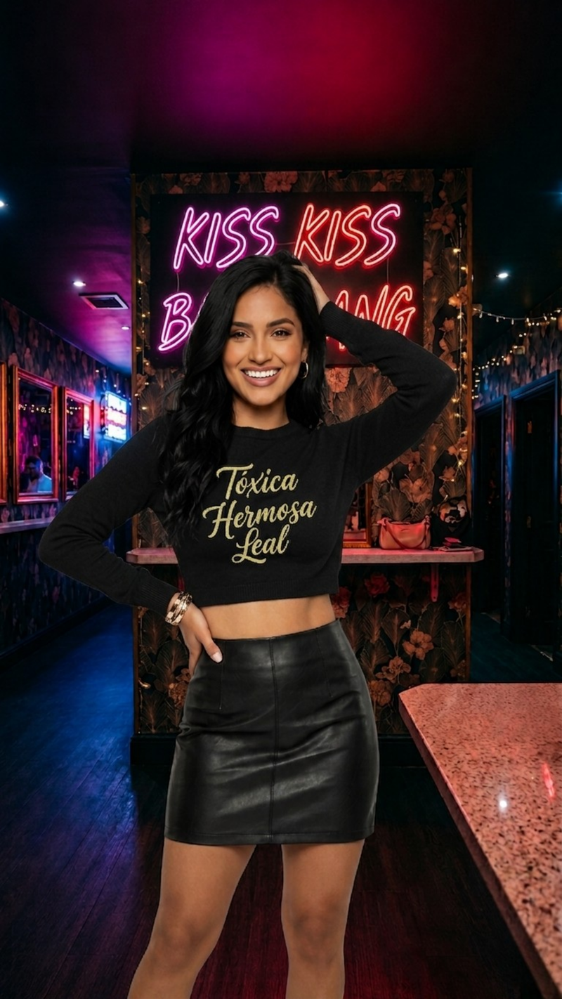 Woman in a black outfit with a neon sign in the background