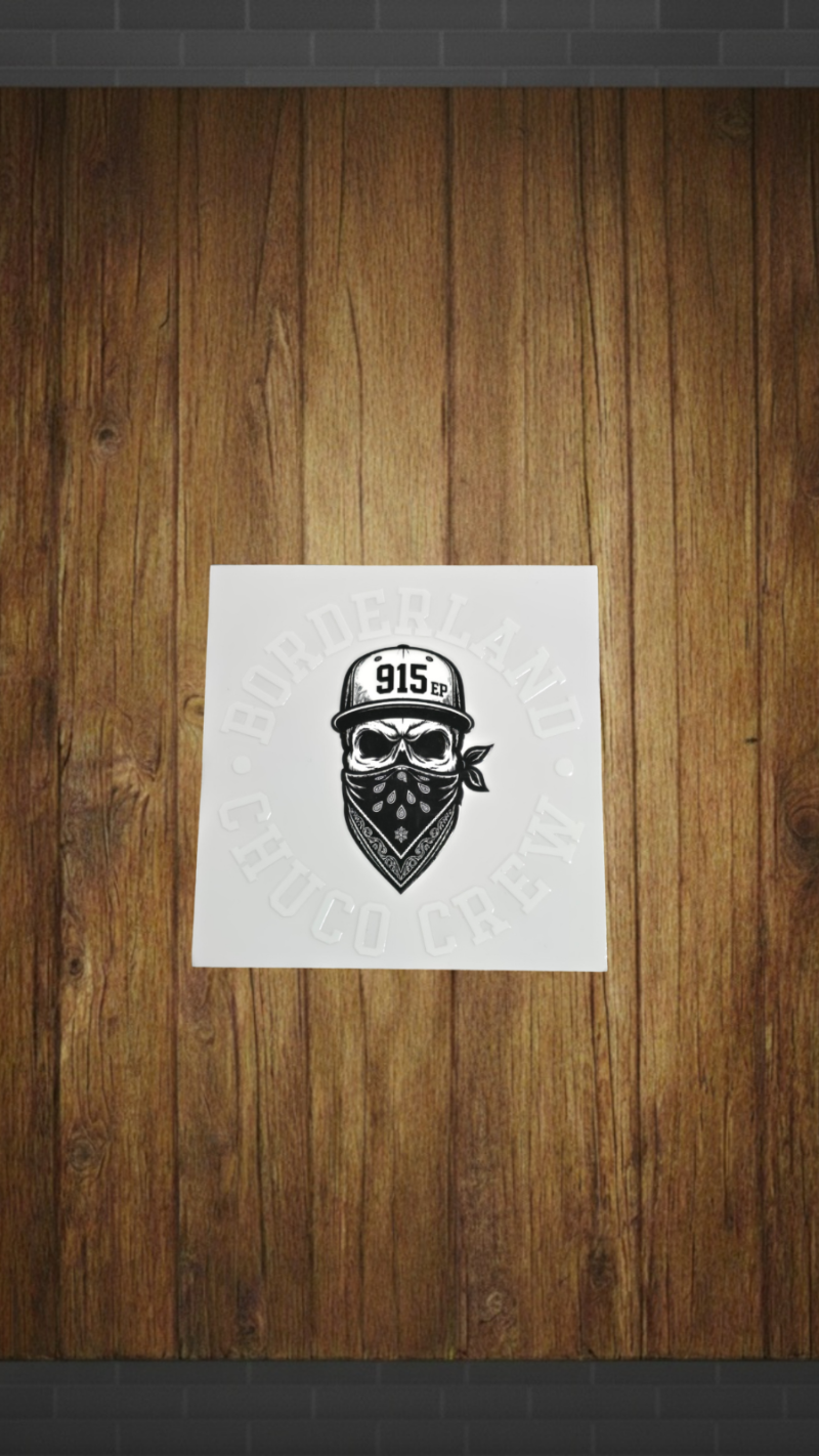 A square white art print featuring a black graphic of a skull wearing a bandana and a cap with '915' on it, displayed against a rustic brown wood plank wall.