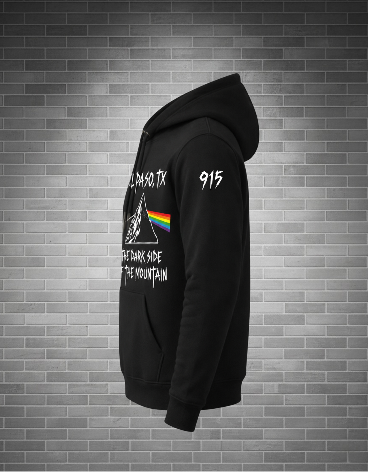 side view black hoodie 915 on sleeve grey brick background